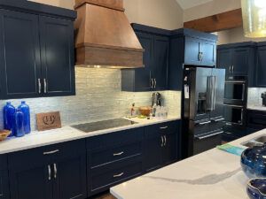 Stove top, custom cabinetry and backsplash in remodeled kitchen.
