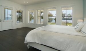 Bedroom with double-door patio access and many lovely windows