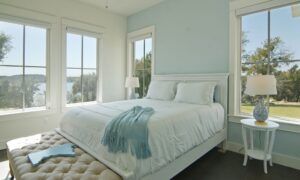 Bedroom with many windows and lake view